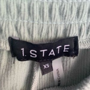 Sleeveless olive top with ankle cropped with elastic.